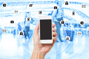 Hand holding mobile phone over double exposure of blurred people travel and data management system internet of things graphics design