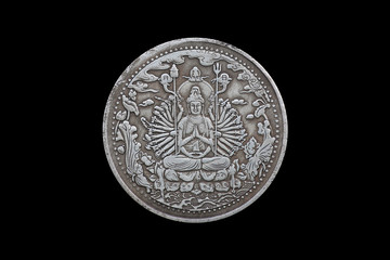Old Chinese coin with guanyin isolated on black background