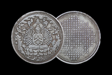 Old Chinese coin with guanyin isolated on black background.