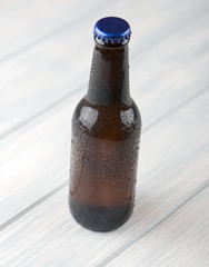 Bottle of beer on wooden table. Alcohol.