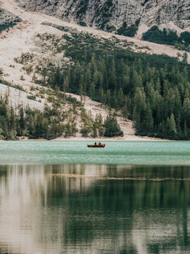 People in boat floating in lake
