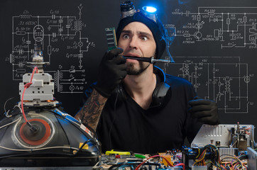 the man is engaged in repair of electronics