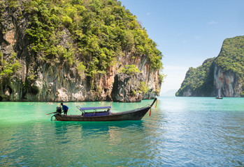 Naklejka na ściany i meble Beautiful landscape of rocks mountain and crystal clear sea with longtail boat at Phuket, Thailand. Summer, Travel, Vacation, Holiday concept.