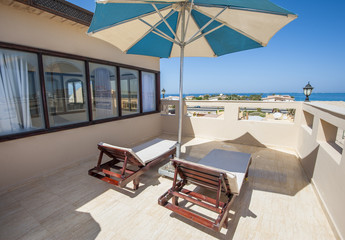 Roof terrace with sun beds in luxury apartment