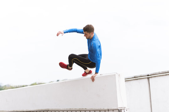 Young athlete crossing a wall