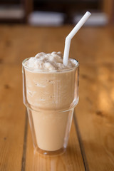 ice coffee and caramel smoothie on wooden table.