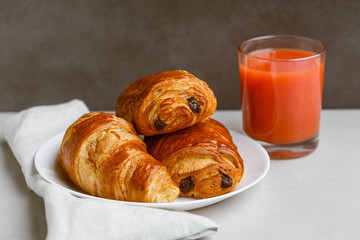 Croissant,  pain au chocolat and orange juice
