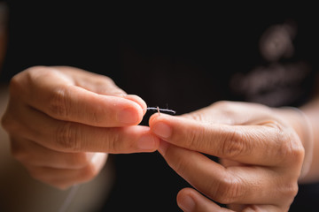 Woman's hand sewing fabric with sewing equipments