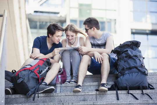 Young people exploring Berlin, looking at map