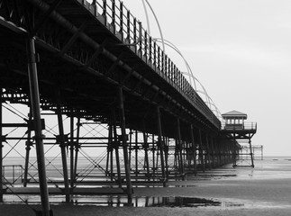 southport pier showing beach and structure in the evening monochrome