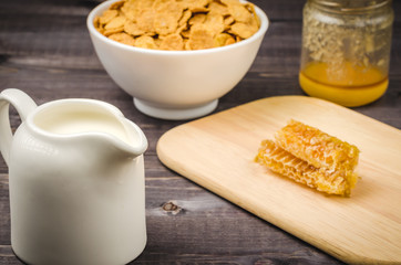 milk, flakes and honey breakfast background/breakfast background with milk, flakes and honey