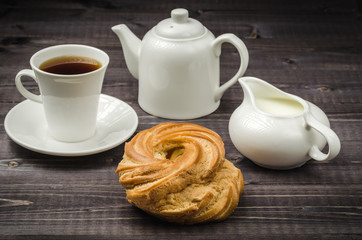 cup, coffee, creamer, teapot, sweets/cup, coffee, creamer, teapot, sweets on a dark table