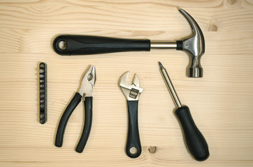 Instruments on wooden background. Hand working tools on wooden table.