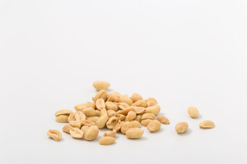 Fototapeta na wymiar Fried salted peanuts on white background. snack.