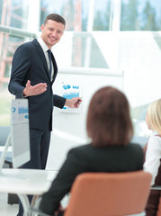 Attractive man making a business presentation to a group