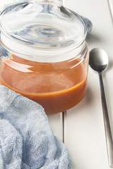Salted caramel in a jar, dessert spoon, selective focus, vertical
