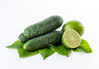 Lime cucumbers and green leaves