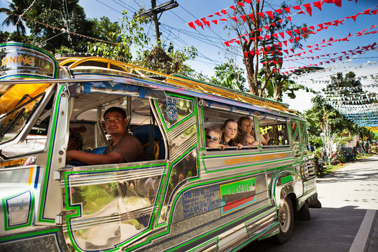 Bus driving on road with colorful flags