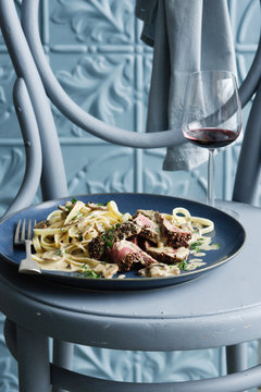 Bowl of beef stroganoff with wine