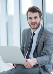 Fototapeta premium Happy young business man work in modern office on computer