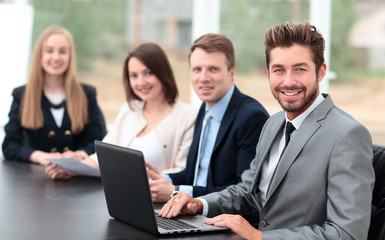 Fototapeta premium Elegant co-workers looking at camera during meeting in office