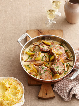 Dish of pork cutlets and apples
