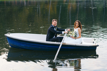 The bride and groom in a rowboat on the lake