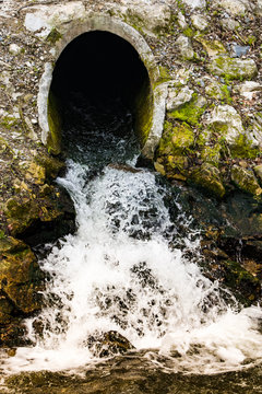 Waste water flowing out of a sewage pipe