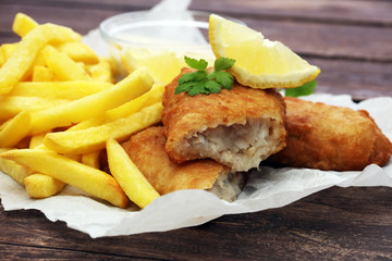 traditional British fish and chips on wooden background