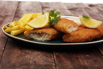 traditional British fish and chips on wooden background