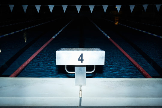 Springboard over lap pool at night