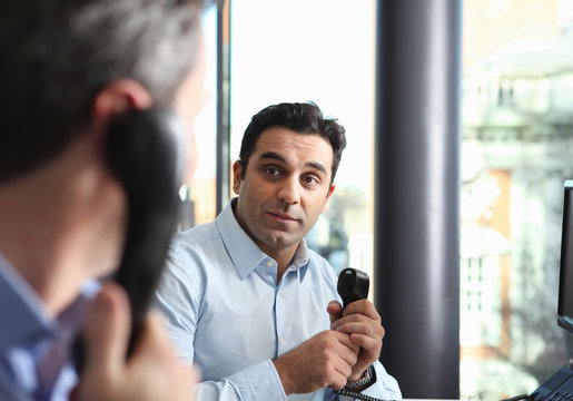 Businessmen talking on cell phones