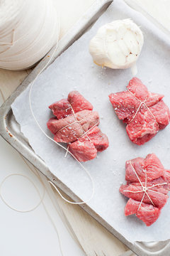 Tray of meat with garlic and salt