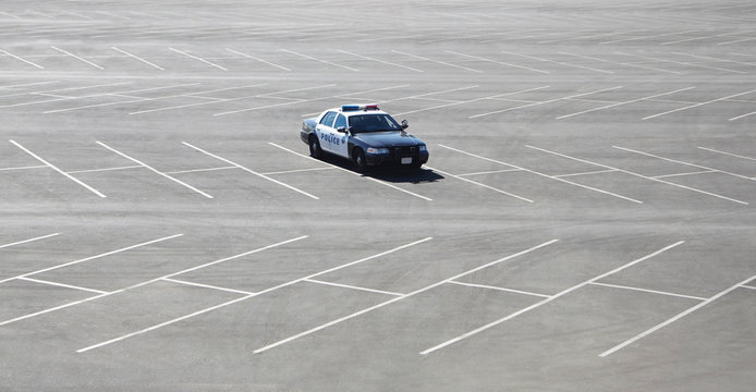 Police car parked in empty lot