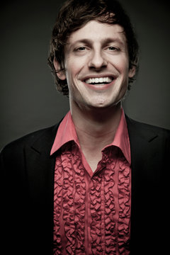Portrait of man wearing red frilly shirt