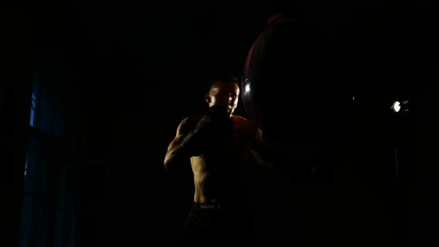 Boxer training in a gym, dramatic lighting. 4k