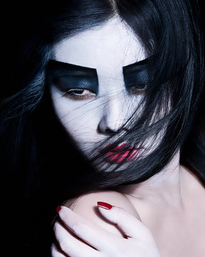 Young woman with dramatic makeup, black eyeshadow