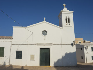 Port de Fornells, Menorca. Balearics islands. Spain. Europe. Sant Antoni Abad Church and the bell tower