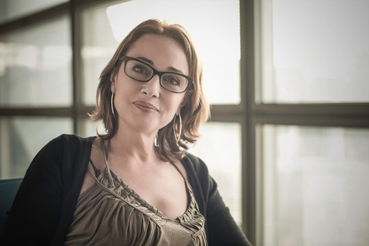 Portrait of mature woman wearing glasses looking at camera