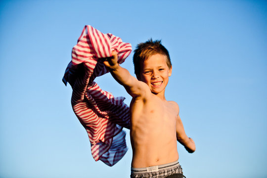 Boy playing with striped fabric