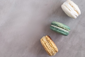Colorful assorted french macaroons on a gray concrete background.  Close up 