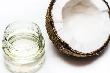 A jar of melted coconut oil and coke on a white background