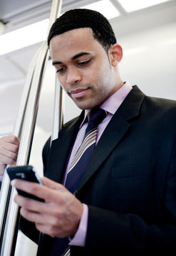 Businessman on train using smartphone