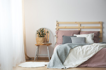 Wooden bed in bedroom