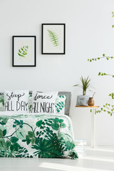 White bedroom with leaf posters