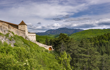 Beautiful spring view of the entrance in the Rasnov citadel in Brasov county (Romania), with Postavaru mountains in the background