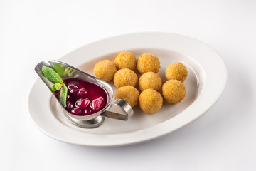 Cheese balls appetizers with sauce on a white plate