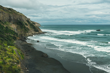 Volcanic beach with black sand and blue ocean