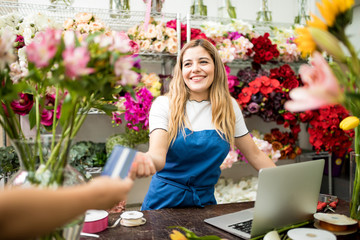 Florist taking a credit card payment in her shop