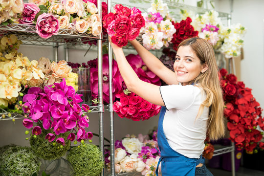 Female worker organizing artificial flowers